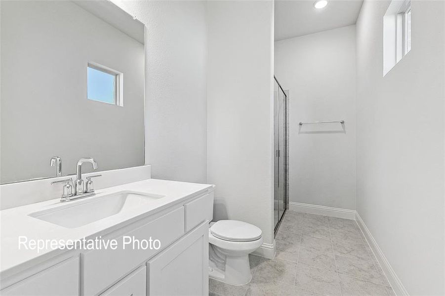 Bathroom featuring tile floors, toilet, and large vanity