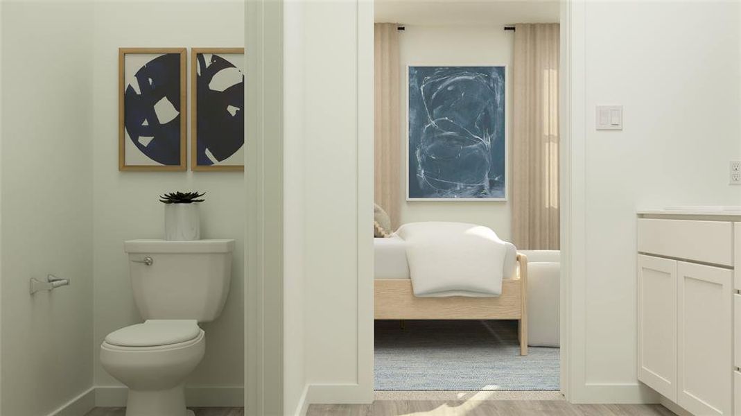 Bathroom with hardwood / wood-style flooring, vanity, and toilet