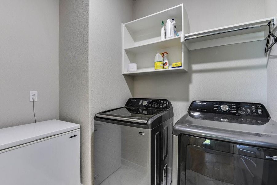 Separate laundry room with extra storage space.