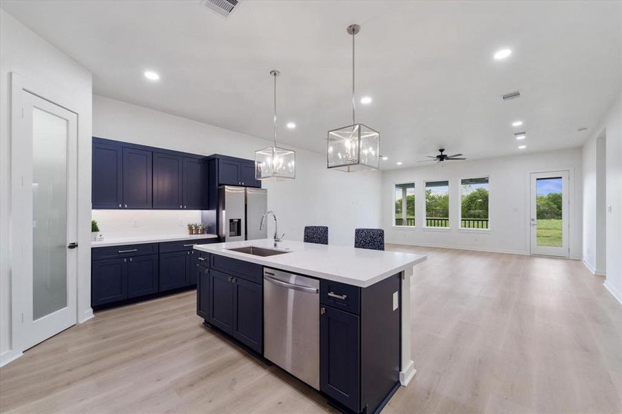 Quartz countertops, Midnight blue soft close cabinets, stainless steel appliances, Undermount cabinet lighting, walk in pantry, pre wired for home security, entertainment, internet,ceiling accent lighting.