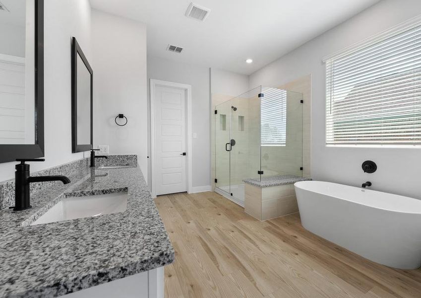 The master bath has a large vanity and a walk-in shower.