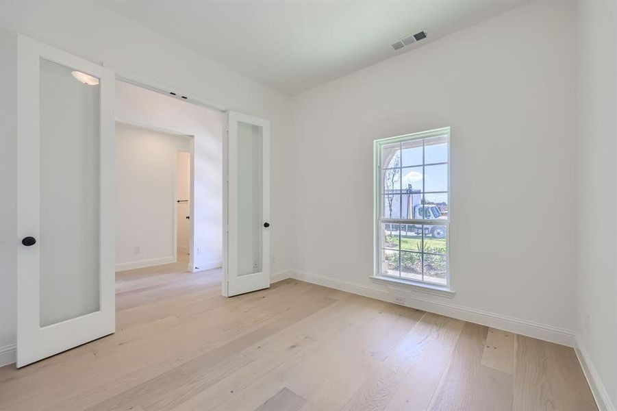 Empty room with light hardwood / wood-style floors