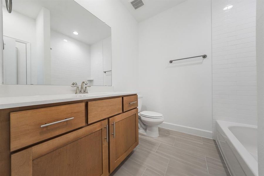 The Secondary Bathroom is located near the two Secondary bedrooms! (Sample photos of a completed Lisbon floor plan. The image may feature alternative selections and/or upgrades.)