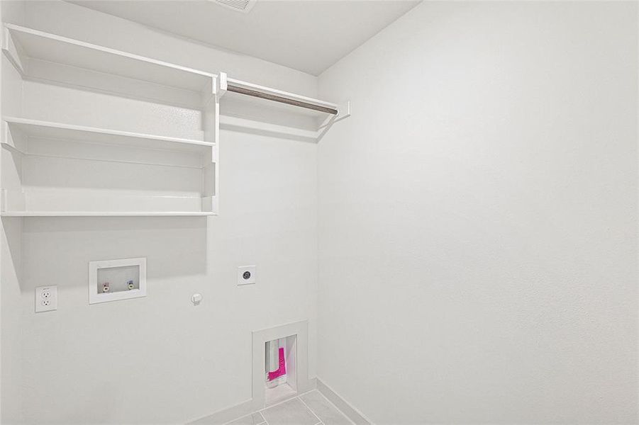 Laundry room featuring hookup for a gas dryer, electric dryer hookup, light tile patterned floors, and hookup for a washing machine