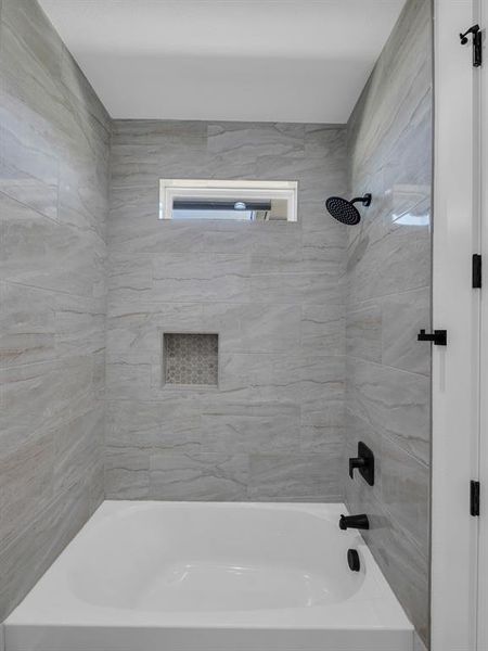 Bathroom featuring tiled shower / bath