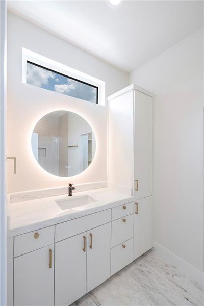 Bathroom with a wealth of natural light and vanity