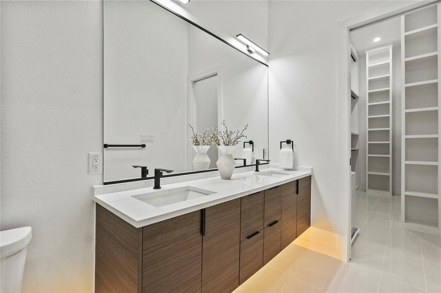 Bathroom featuring vanity, toilet, and tile patterned flooring