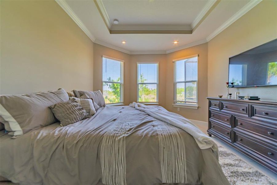 Primary bedroom boasts bay window with seating area