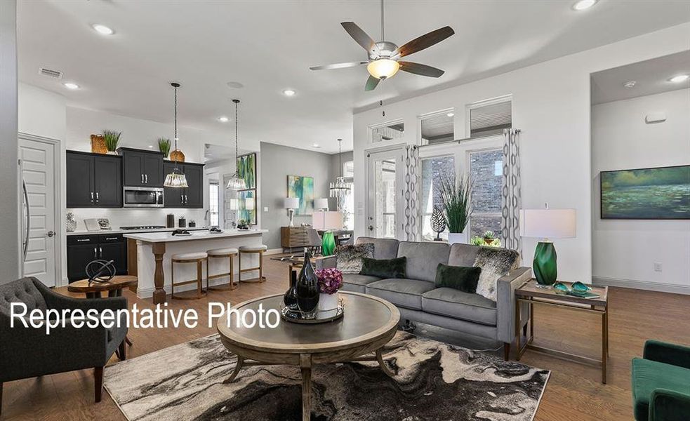 Living room featuring dark hardwood / wood-style flooring and ceiling fan