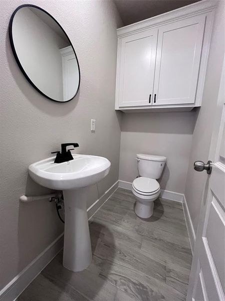 Bathroom with wood-type flooring and toilet