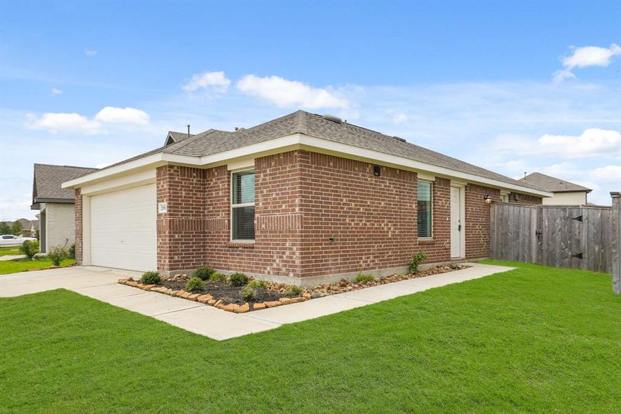 Approaching the front door you will see the warm brick elevation. It's tucked away on the side of the home providing additional privacy.