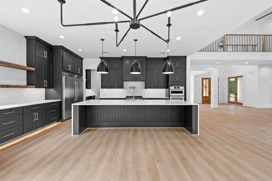 Sleek & elegant kitchen with ample cabinets, under mount and toe kick lighting.