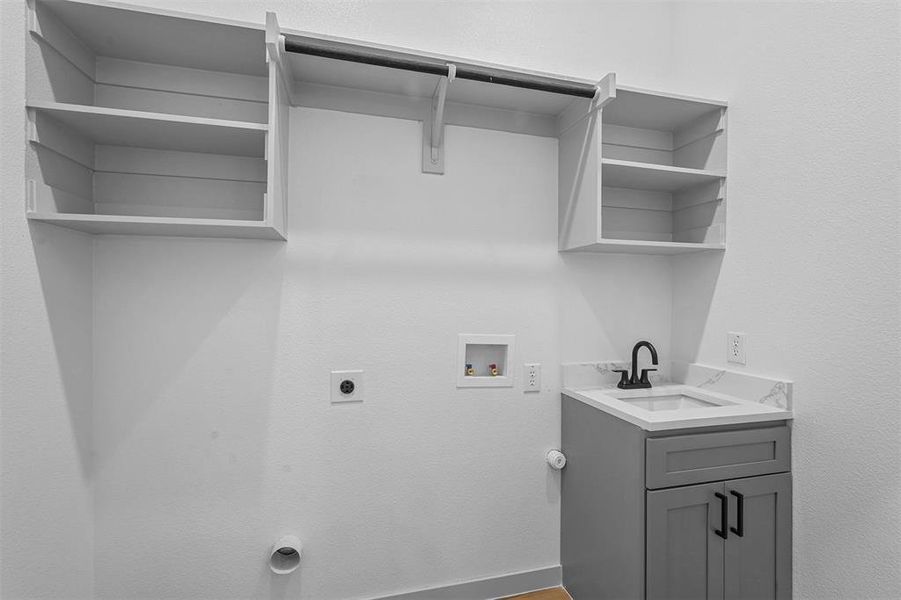 Laundry area featuring hookup for a washing machine, electric dryer hookup, and sink