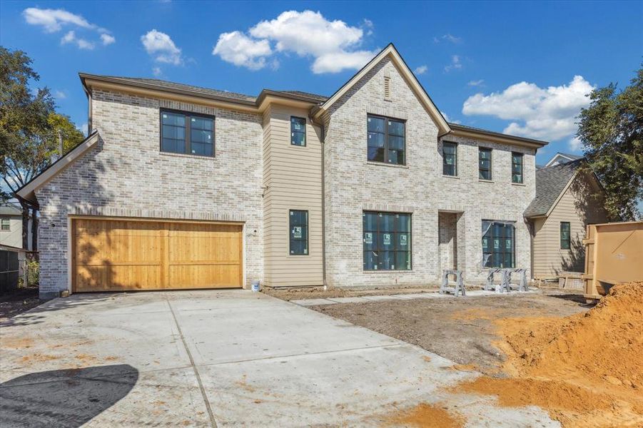 Progress picture (10/20/2024). Front elevation with a 2 car garage. ample parking space, and spacious front yard.  Brick to be finished with slurry and landscaping to be added in the next few weeks.The property is in its final stages of completion and will be ready December 15, 2024.