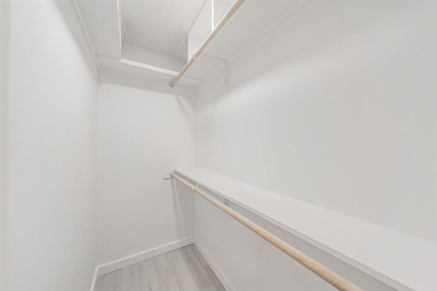 Spacious closet featuring light wood-type flooring