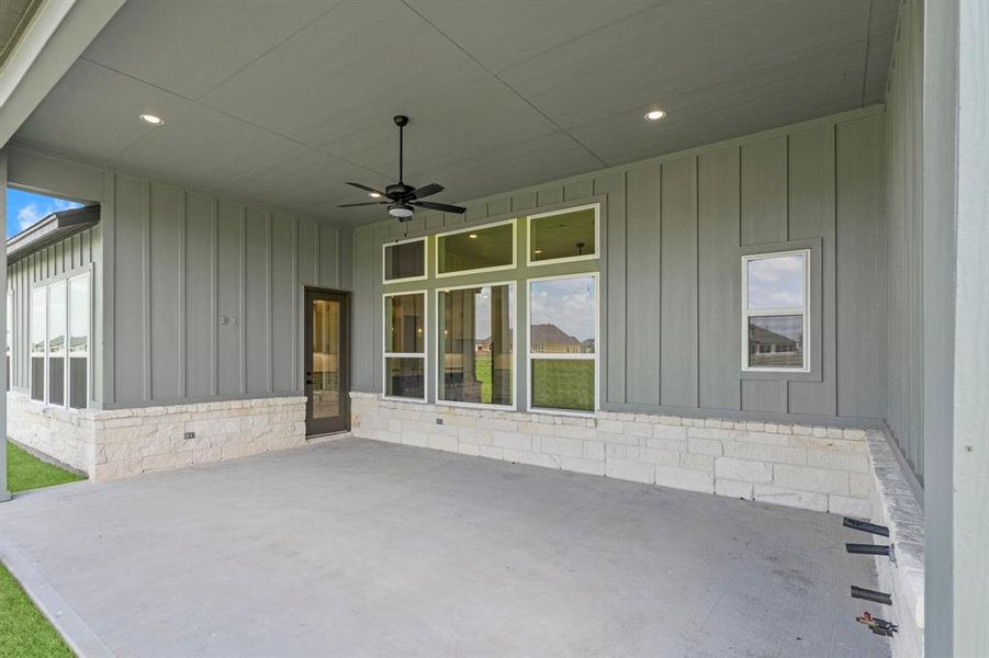 Spacious Covered Rear Patio with Fan, Recessed Lighting, Gas and Water Connections, and Electrical Outlet.