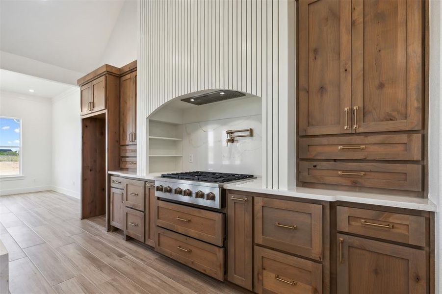 Kitchen with light hardwood / wood-style floors and cooktop