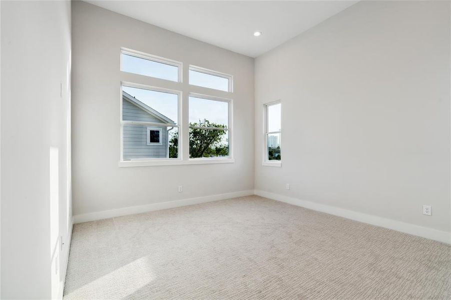 The primary bedroom is grand in size and also has plenty of windows for natural light.