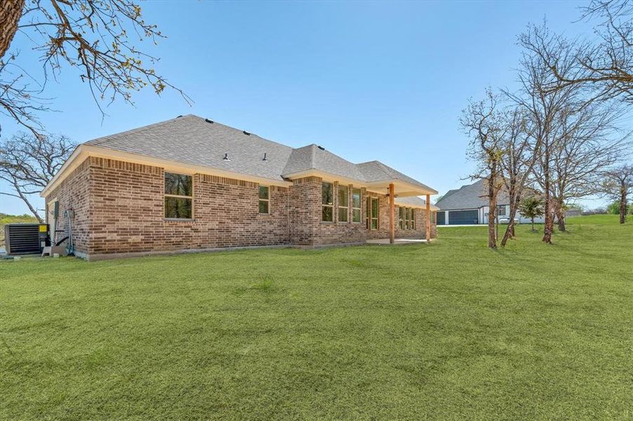 Rear view of property featuring a yard