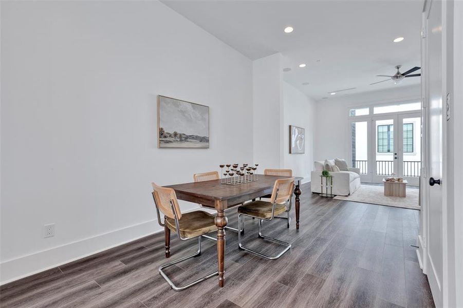 Additional view of the dining area with a glimpse of the living room in the background.