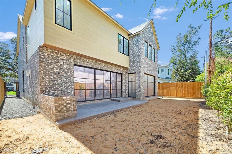 Brick and artisan board exterior. Pergola with summer kitchen and built-in grill.Construction picture taken October 17, 2024.