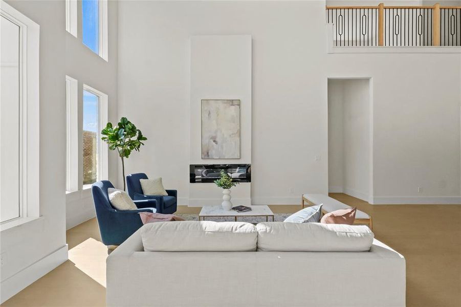 Living room with a towering ceiling and plenty of natural light