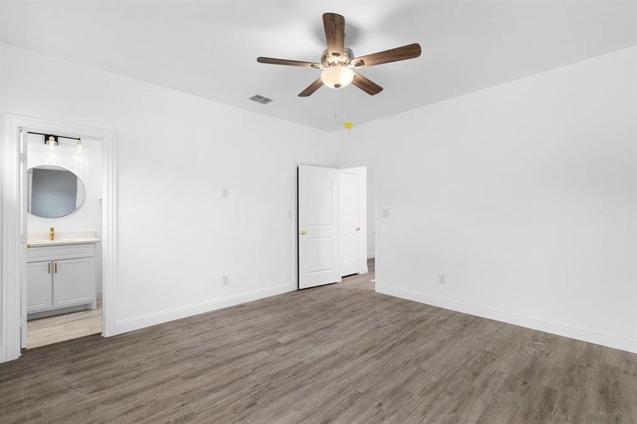 Spare room featuring ceiling fan and dark hardwood / wood-style floors