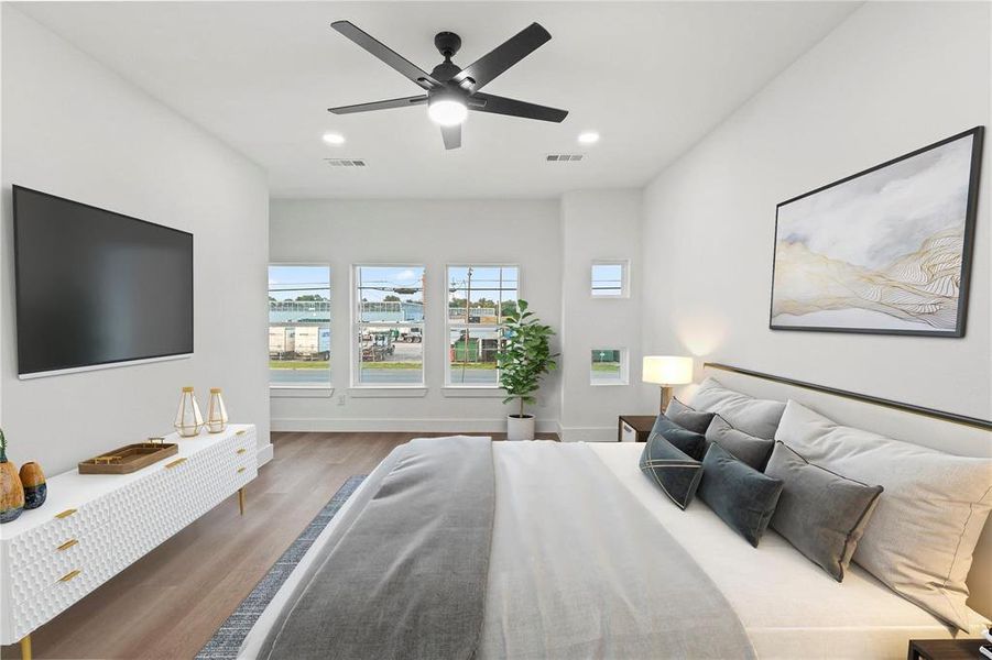 Bedroom with ceiling fan and hardwood / wood-style floors