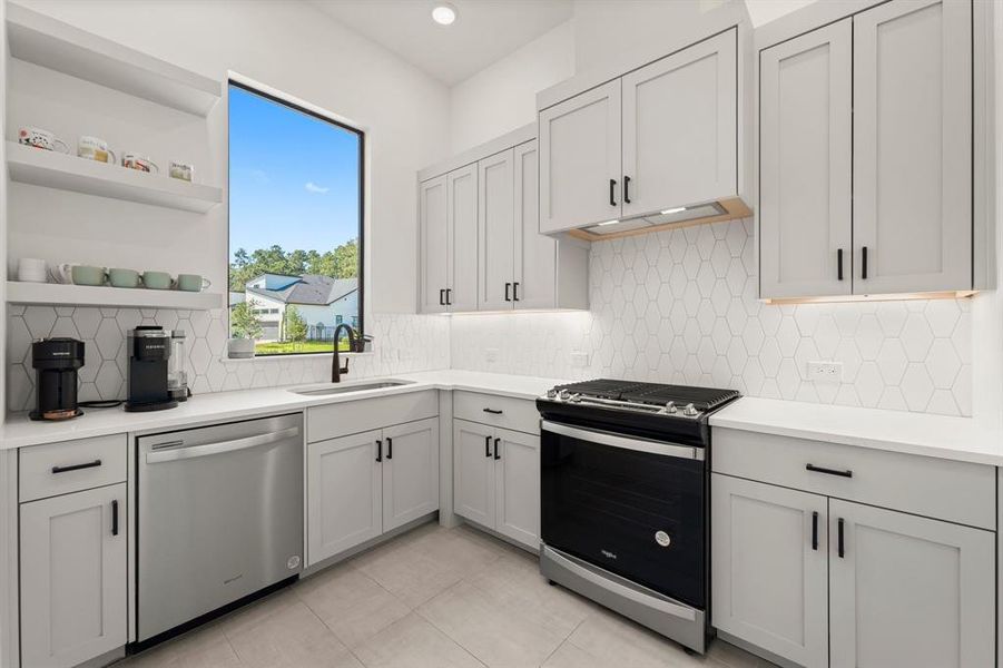 Nicely equipped service kitchen hidden from view, perfect for party prep.