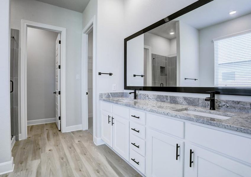 Relaxing master bathroom with a dual-sink vanity, walk-in shower, and soaking tub.