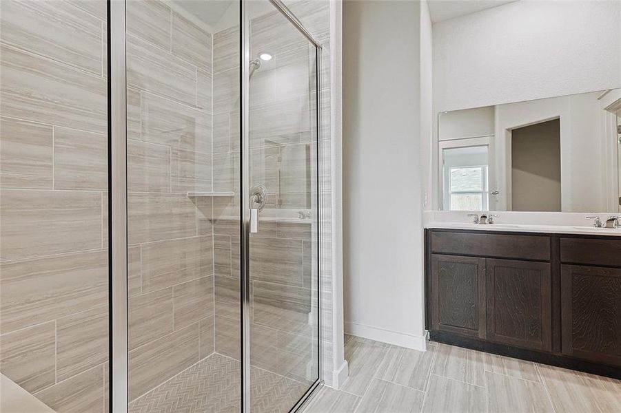 Bathroom featuring vanity and a shower with shower door