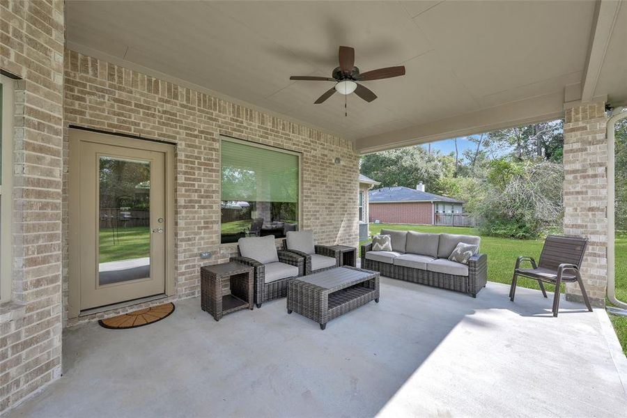 Relaxing oversized covered patio, and brick on all sides