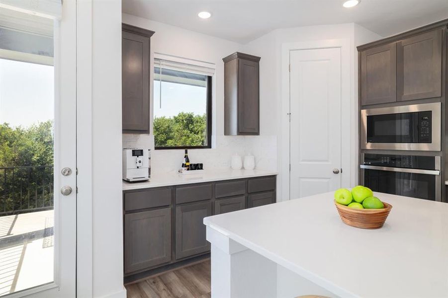 The kitchen is located at the back of the house, afffording a beautiful view of the greenspace behind.