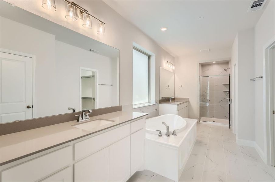 Bathroom with independent shower and bath, tile patterned flooring, and double sink vanity