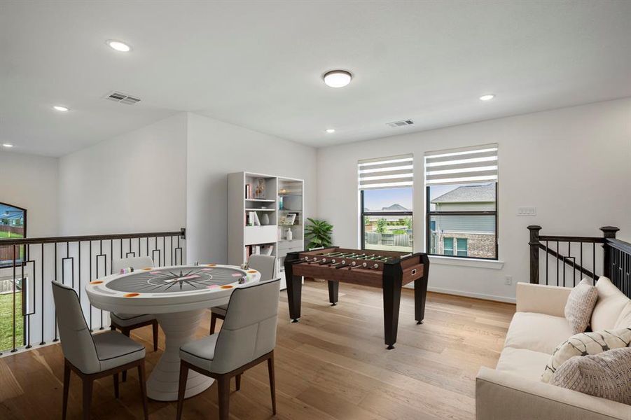 Upstairs you walk into a large game room that's perfect for a tv's, games, or a lounging space! Upgraded with modern iron balusters and wood flooring. *This room has been virtually staged