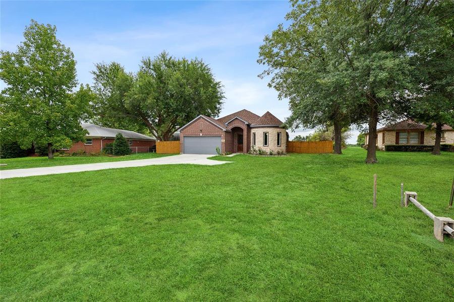 Ranch-style house with a garage and a front yard