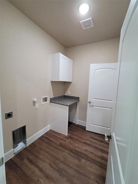 Laundry area with electric dryer hookup, cabinets, dark wood-type flooring, and washer hookup