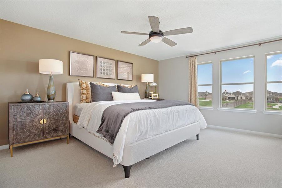 Come and unwind after a long day in this magnificent primary suite! This spacious room features plush carpet, neutral paint, high ceilings with ceiling fan, and a wall of large windows!