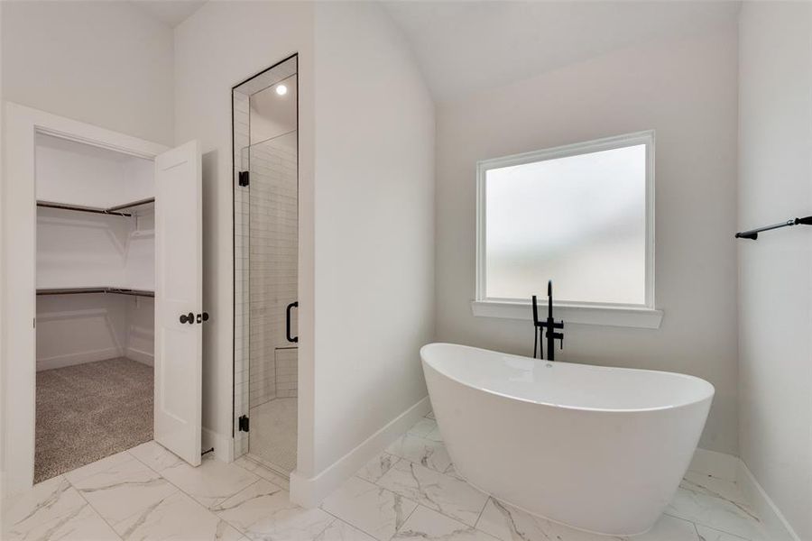 Bathroom with independent shower and bath and tile patterned floors