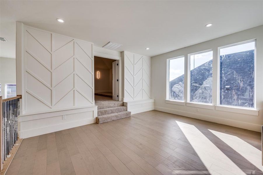 Unfurnished living room featuring a mountain view and light wood-type flooring