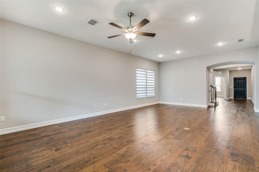 Unfurnished room featuring ceiling fan and dark hardwood / wood-style floors