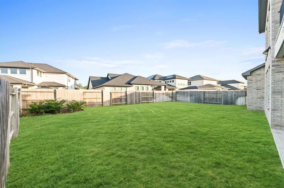 Step into the expansive backyard of this home, where sprawling greenery and open space beckon for outdoor adventures and gatherings.