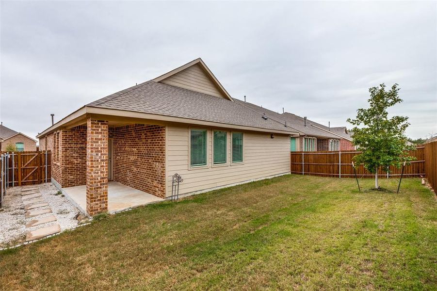 Rear view of house with a patio and a yard