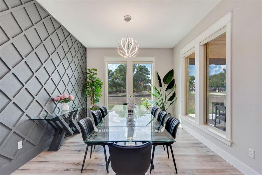 Dining room featuring a chandelier and light hardwood / wood-style floors