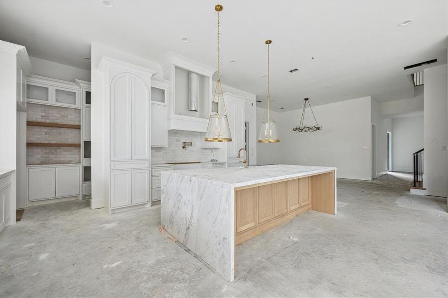 A view toward the open pantry access - this is only a small portion of this amazing pantry.  Open white oak shelves, and soon to be installed built-in coffee machine and microwave drawer.  Photo as of 9/3/2024