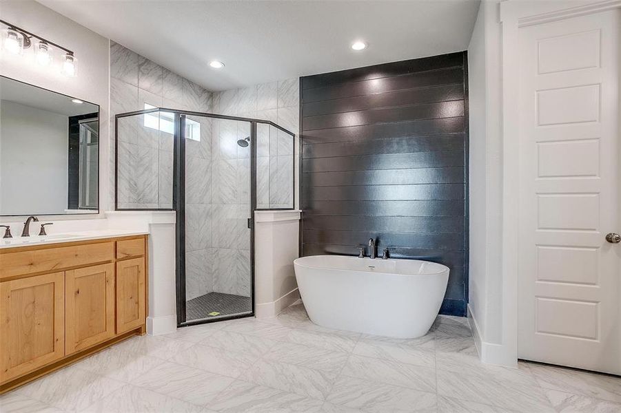 Bathroom with separate shower and tub, tile patterned floors, and vanity