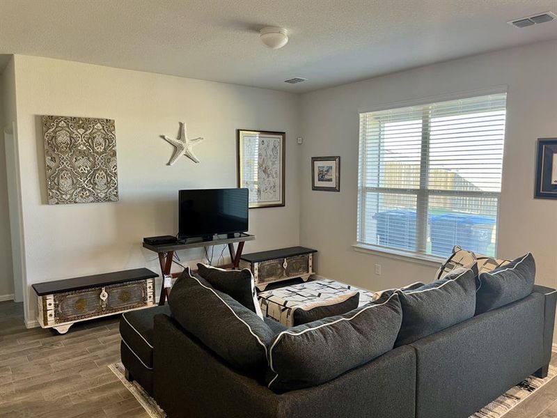 Living room with hardwood / wood-style flooring and a textured ceiling