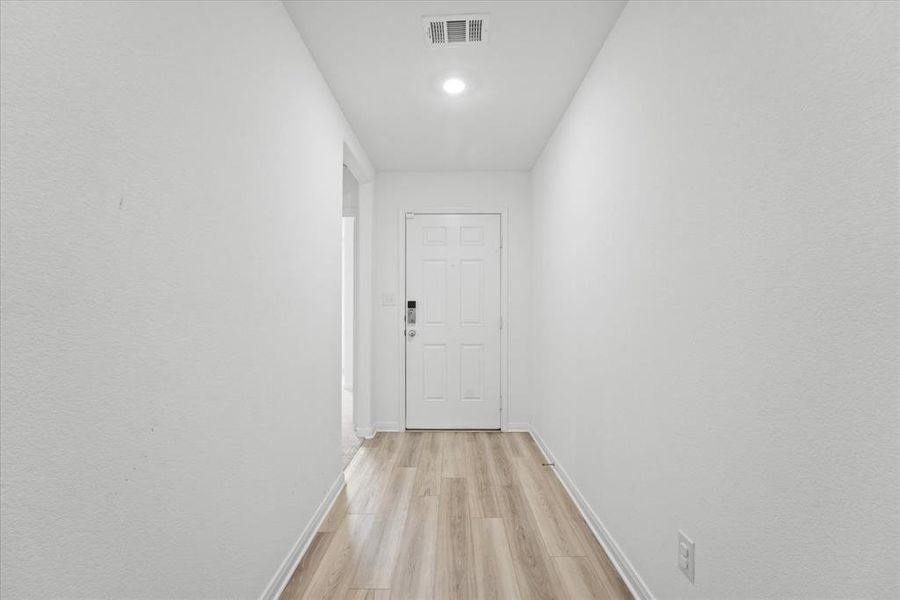 Corridor featuring light hardwood / wood-style flooring