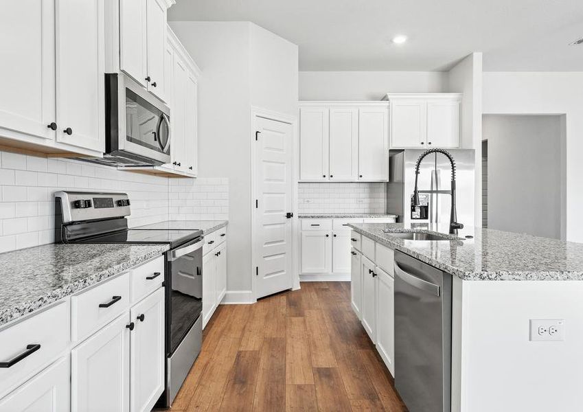 Additional look into the spacious walkway and work areas throughout the kitchen.