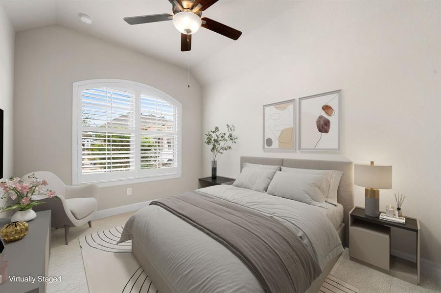 Secondary bedroom features plush carpet, neutral paint, dark stained ceiling fan with lighting and a large window with plantation shutters.